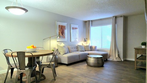 a living room and dining room with a couch and a table
